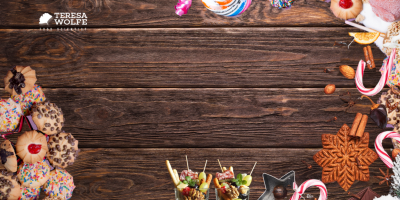 An image of a wooden table top bordered with holiday sweets and treats inspires different responses in people in accordance with their personal 'food story'.
